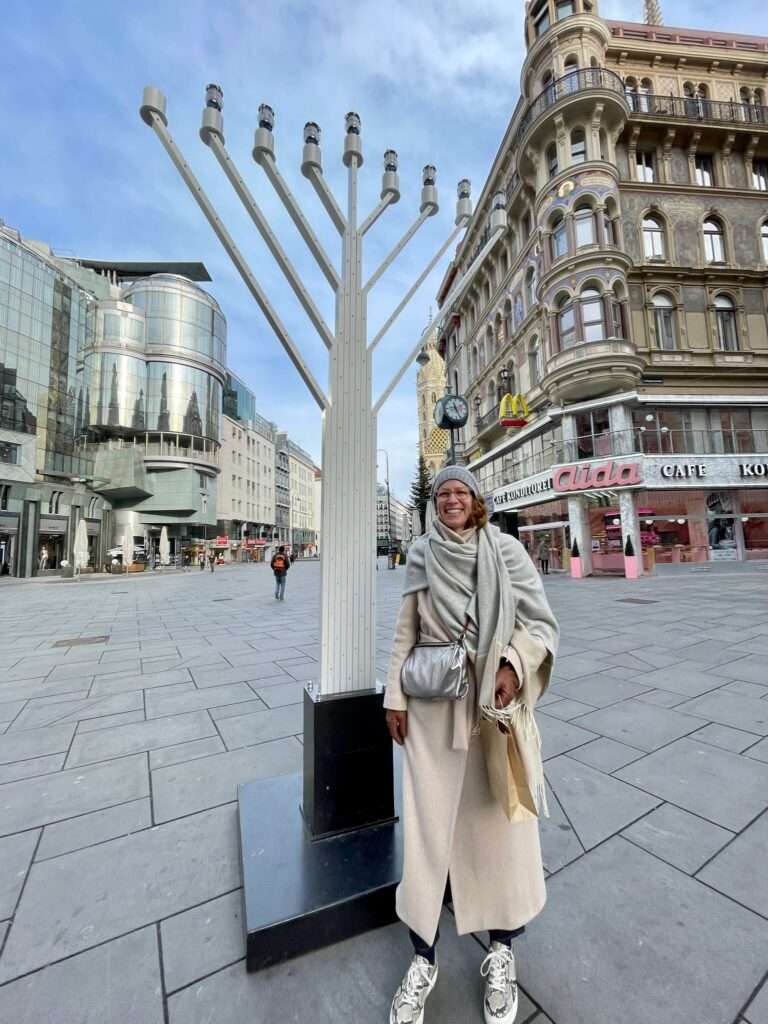 Martha Tretter standing next to the Hanukkah in Vienna