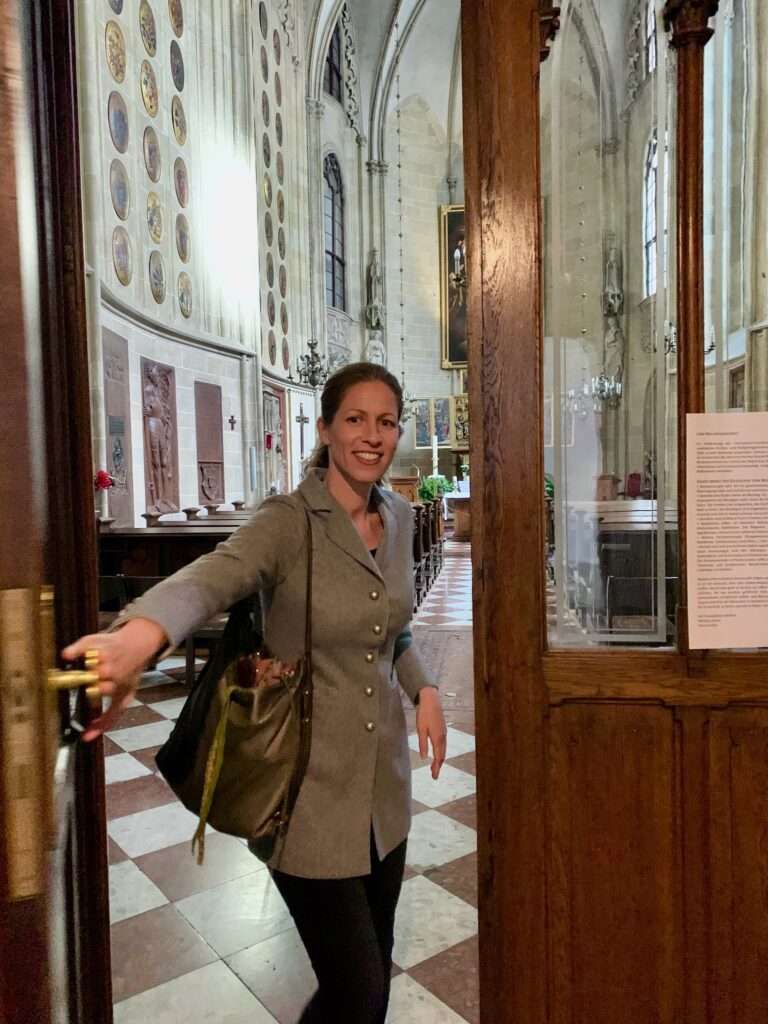 Martha Tretter opens the door to the Deutschordenskirche in Vienna